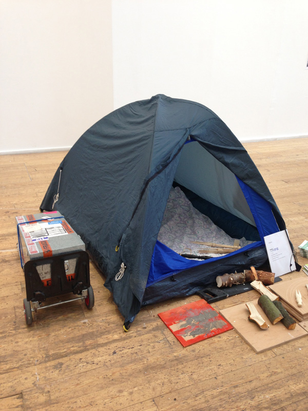 the opening of the tent with green wood work tools